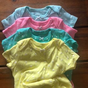 Set of 4 short sleeve polka dot onesies.
